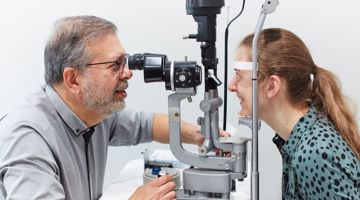 Professor Carlos Pavesio examining a patient's eye