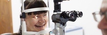female patient smiling at the eye diagnostics