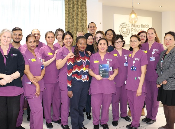 Moorfields Private teams holding a Doctify award trophy