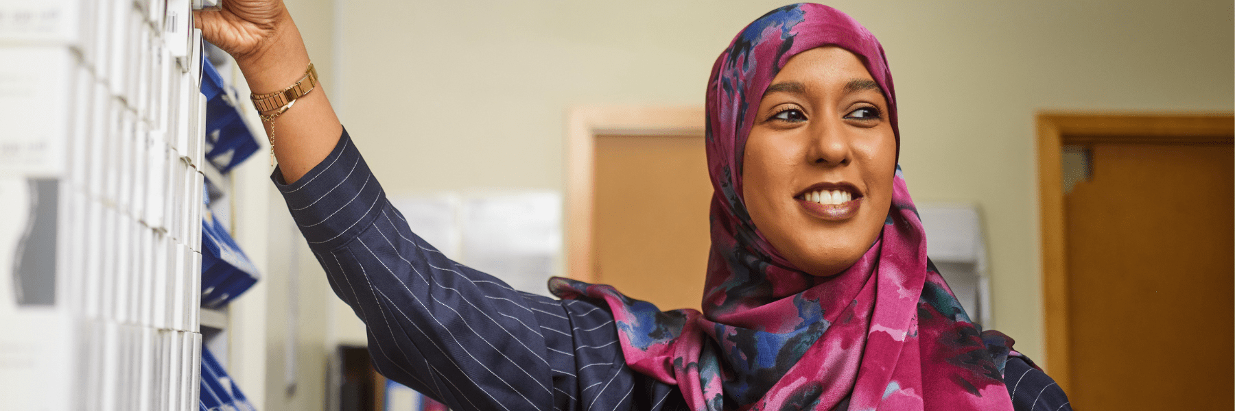 Photo of staff member smiling: Muna headshot in the hospital