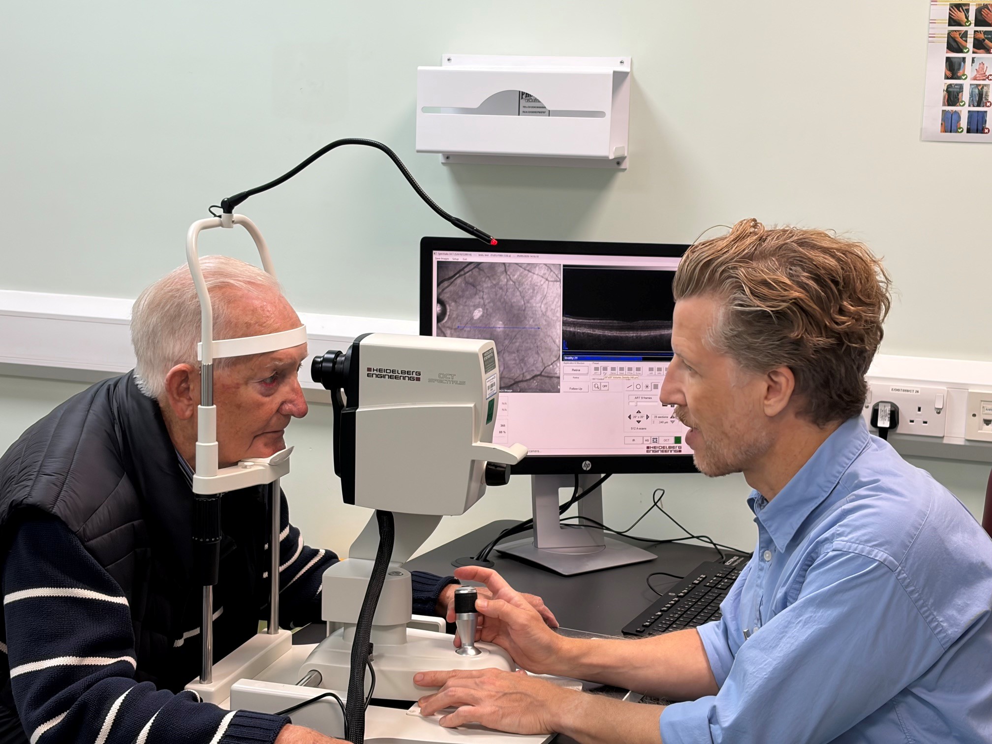 Moorfields consultant looking into patient's eyes