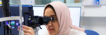 Staff member using a slit lamp