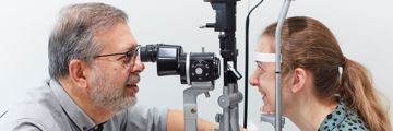 Professor Carlos Pavesio examining a patient's eye