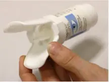 Eye drops bottle placed in an insertion aid