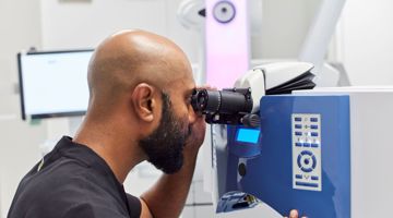A member of the Moorfields using using ophthalmic equipment
