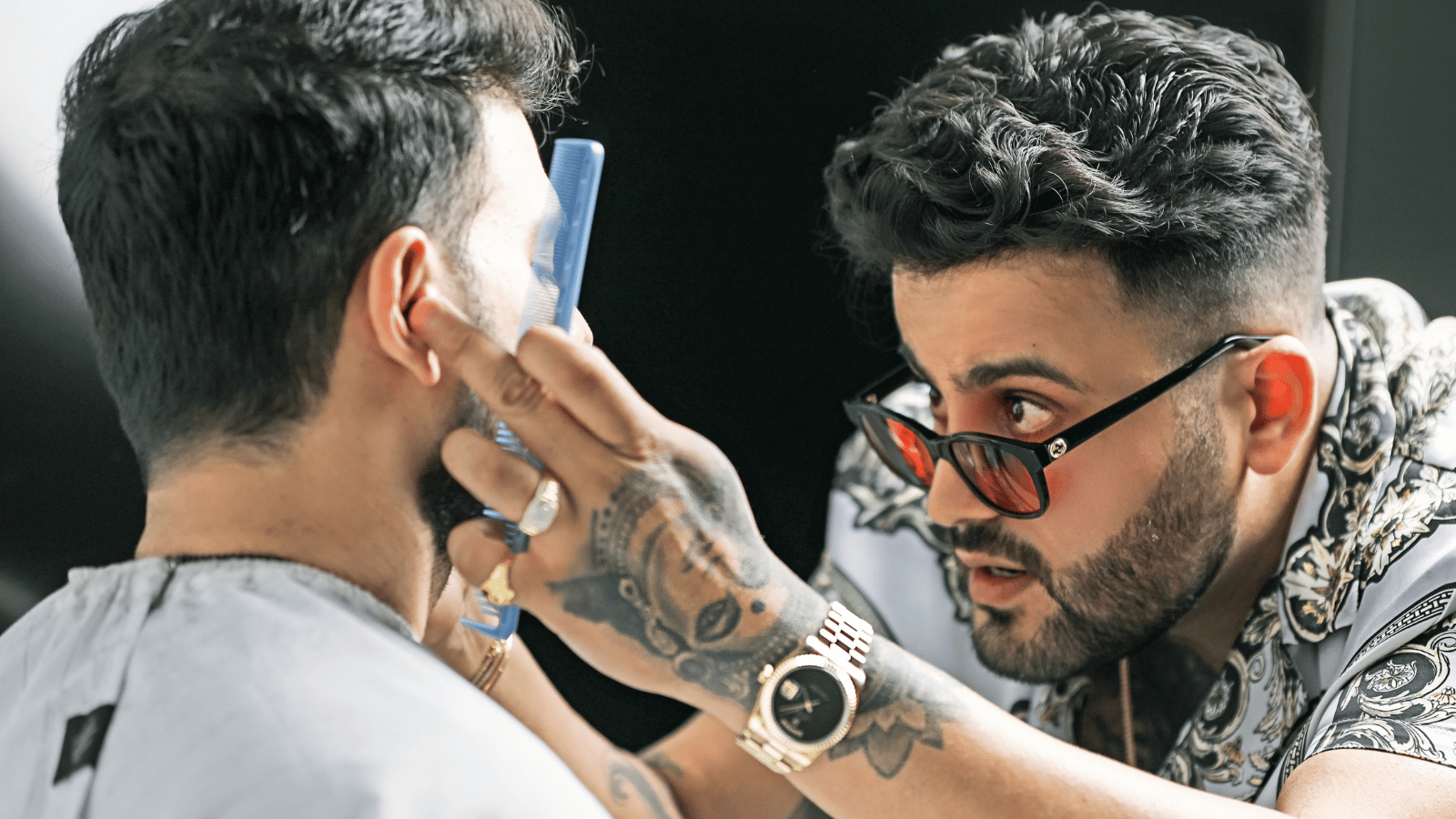 JJ Savani styling hair of a male client