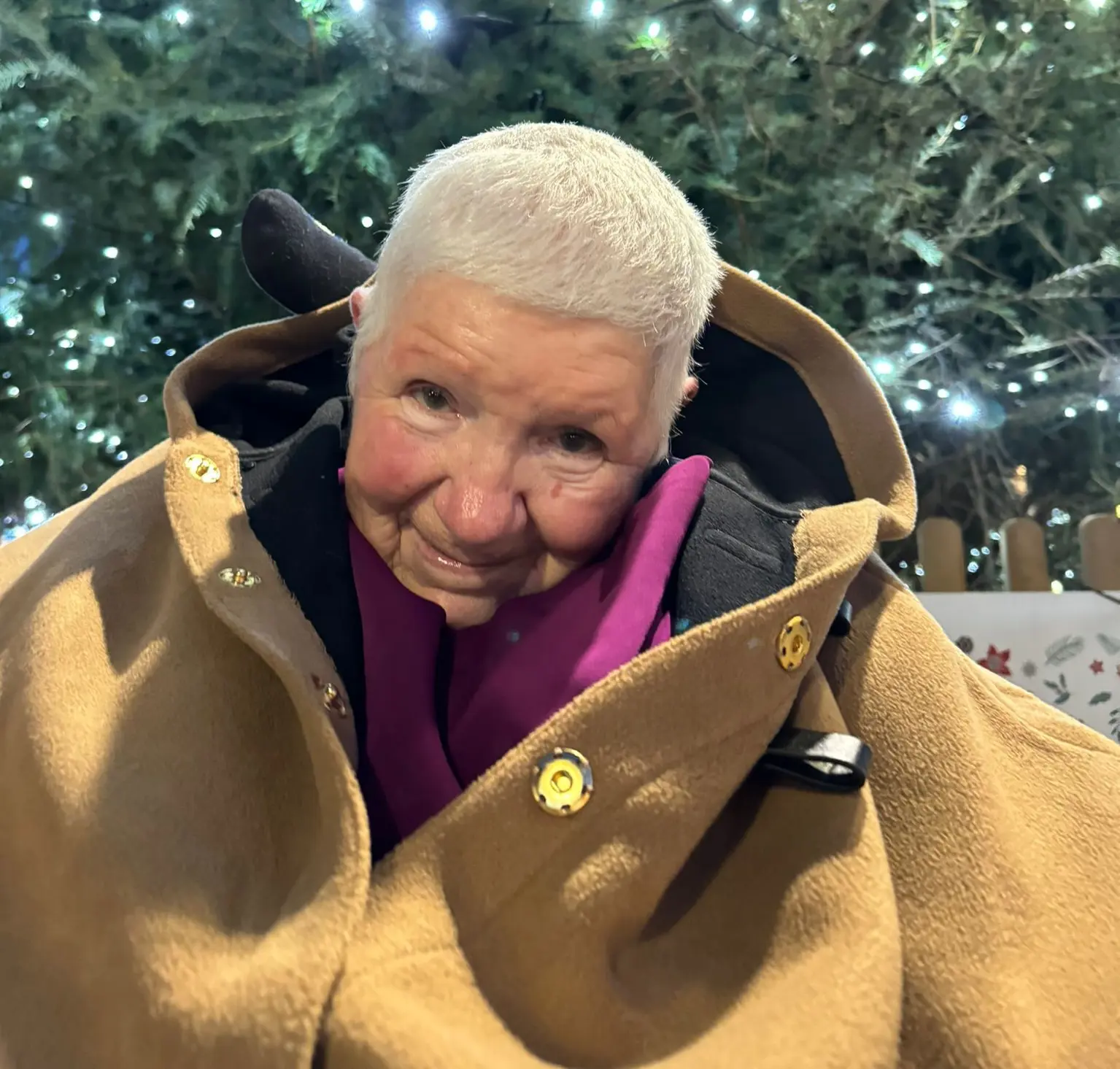 Headshot of Pam Franklin with a coat on and plants in the background