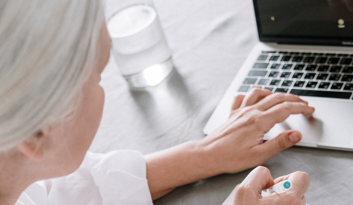 A mature woman typing on her laptop